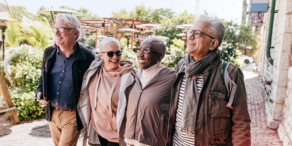 Un groupe de seniors marchent ensemble dans la rue sous le soleil